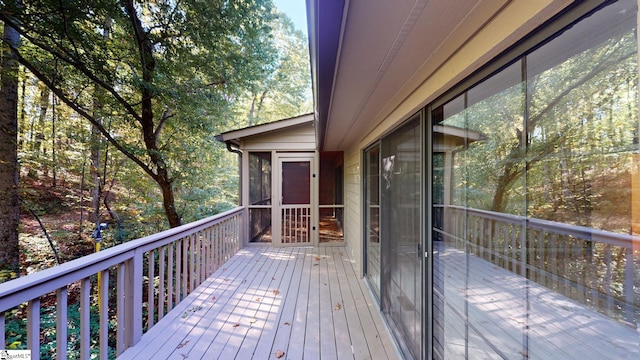 wooden deck with a sunroom