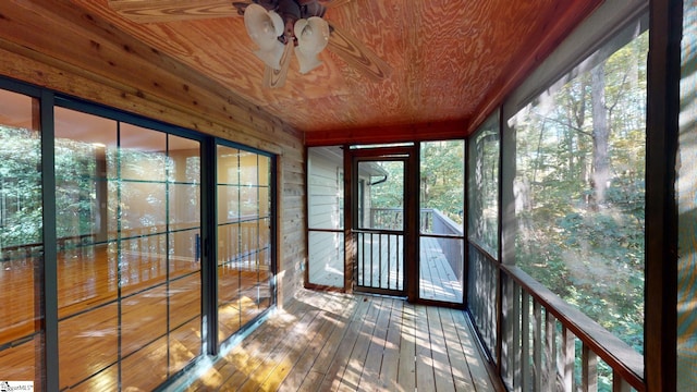 unfurnished sunroom with a healthy amount of sunlight and wooden ceiling