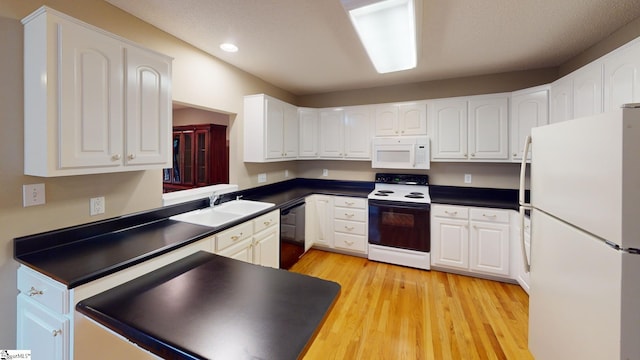 kitchen featuring light hardwood / wood-style floors, white cabinetry, sink, and white appliances