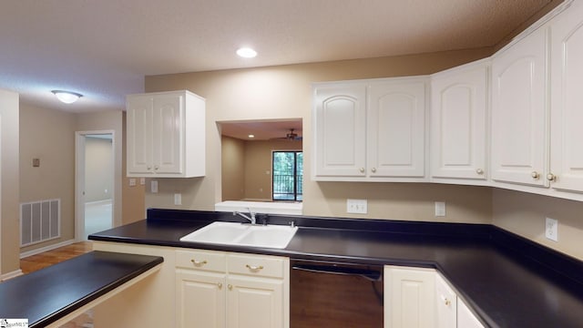 kitchen with sink, dishwasher, white cabinets, and a textured ceiling