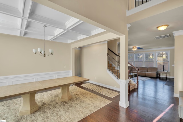 dining space featuring coffered ceiling, dark hardwood / wood-style floors, beamed ceiling, crown molding, and ceiling fan with notable chandelier