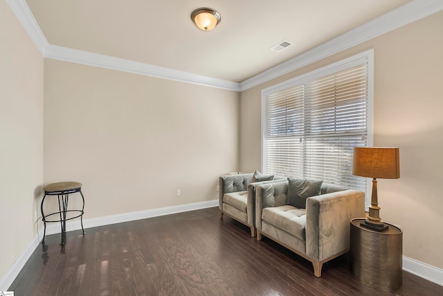 sitting room with ornamental molding and dark hardwood / wood-style floors