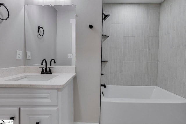 bathroom featuring vanity and tiled shower / bath