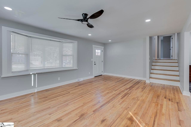 unfurnished living room featuring light hardwood / wood-style flooring and ceiling fan