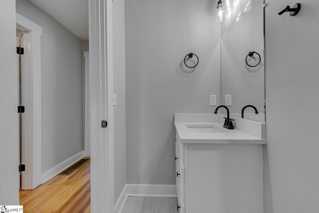 bathroom featuring vanity and hardwood / wood-style flooring