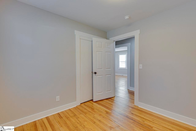 unfurnished room with light wood-type flooring