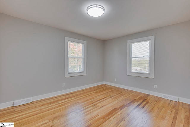 unfurnished room featuring light hardwood / wood-style floors