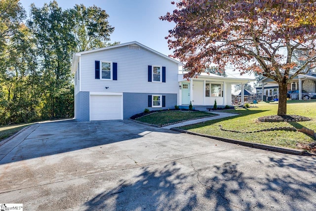 split level home featuring a front yard and a garage