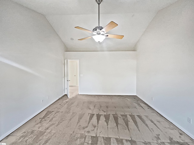 carpeted empty room featuring lofted ceiling, a textured ceiling, and ceiling fan