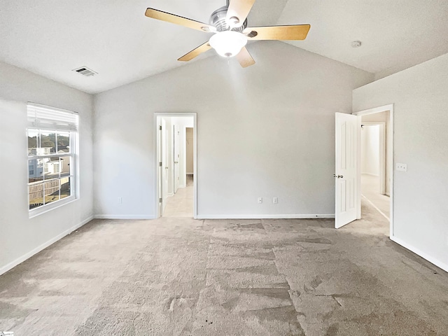 unfurnished room featuring lofted ceiling, carpet, and ceiling fan