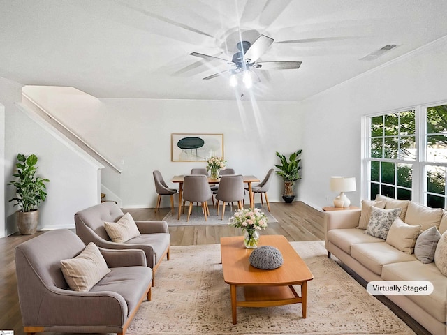 living room with ceiling fan, wood-type flooring, and a textured ceiling