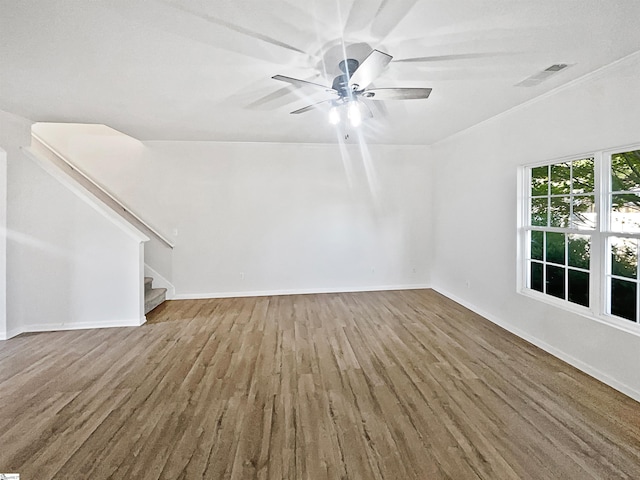 unfurnished living room featuring wood-type flooring and ceiling fan