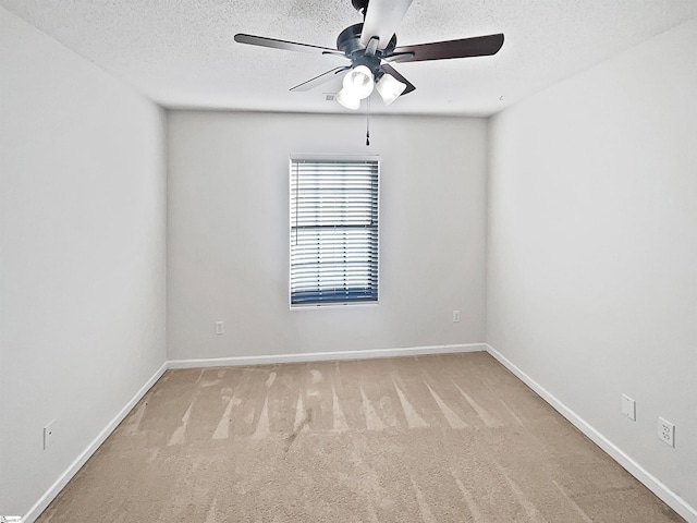 carpeted empty room featuring a textured ceiling and ceiling fan