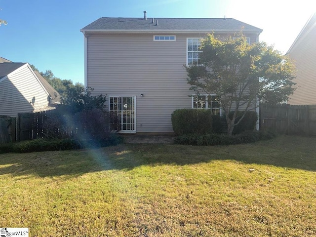 rear view of house with a yard