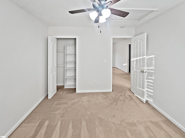 unfurnished bedroom with a closet, ceiling fan, and light carpet