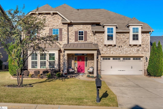 view of front of house featuring a front yard and a garage