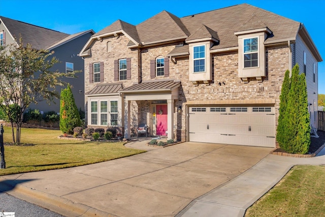 view of front of property with a front lawn and a garage