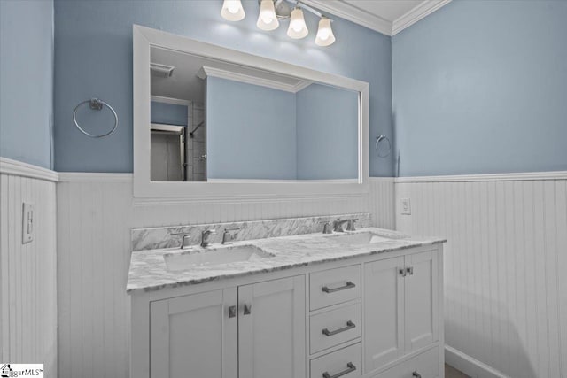 bathroom with crown molding and vanity