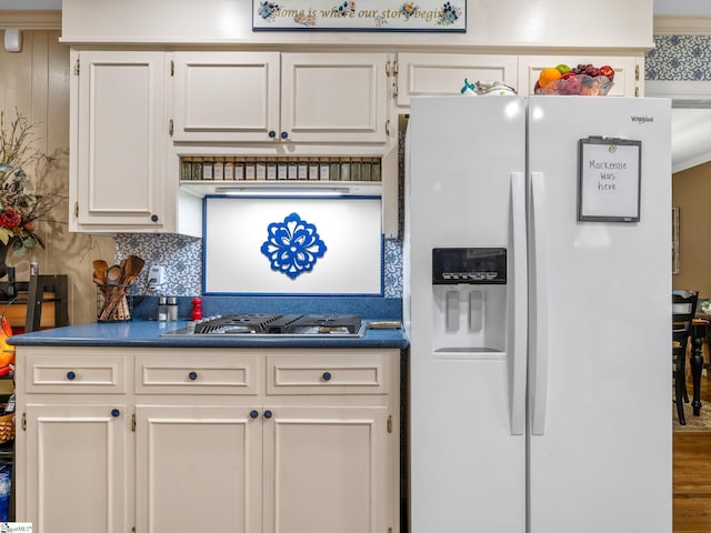 248 Greengate Ln, Spartanburg, SC 29307 - kitchen featuring dark countertops, white fridge with ice dispenser, decorative backsplash, and stainless steel gas cooktop