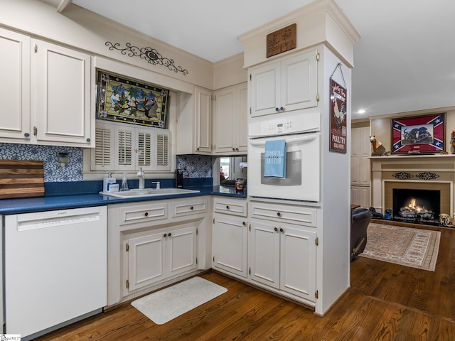 kitchen featuring decorative backsplash, white cabinetry, white appliances, and dark hardwood / wood-style flooring