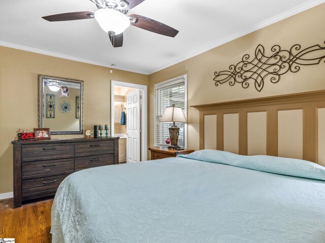 bedroom with connected bathroom, ornamental molding, dark wood-type flooring, and ceiling fan