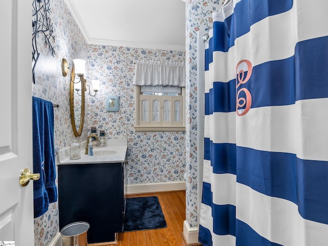 bathroom featuring vanity, wood-type flooring, ornamental molding, and walk in shower