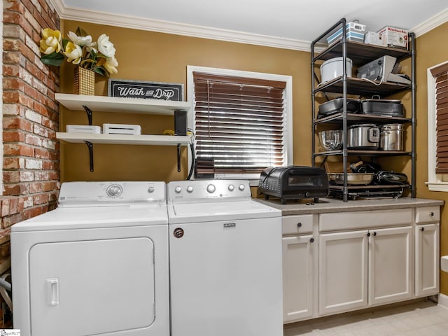 laundry room with brick wall, crown molding, separate washer and dryer, and cabinets