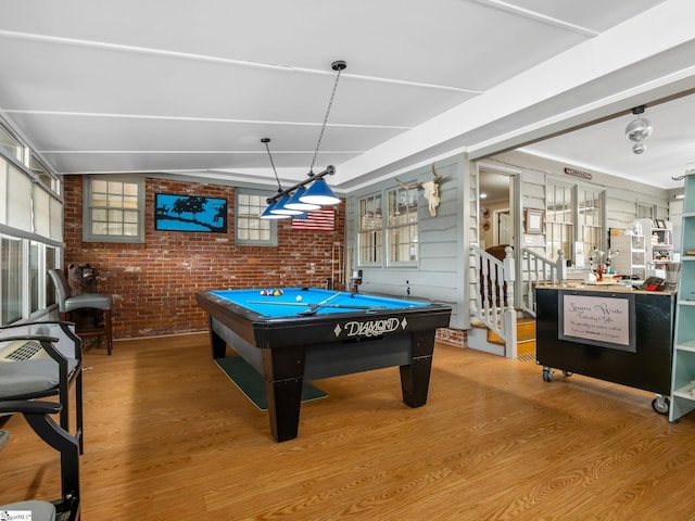 recreation room featuring brick wall, billiards, and hardwood / wood-style floors