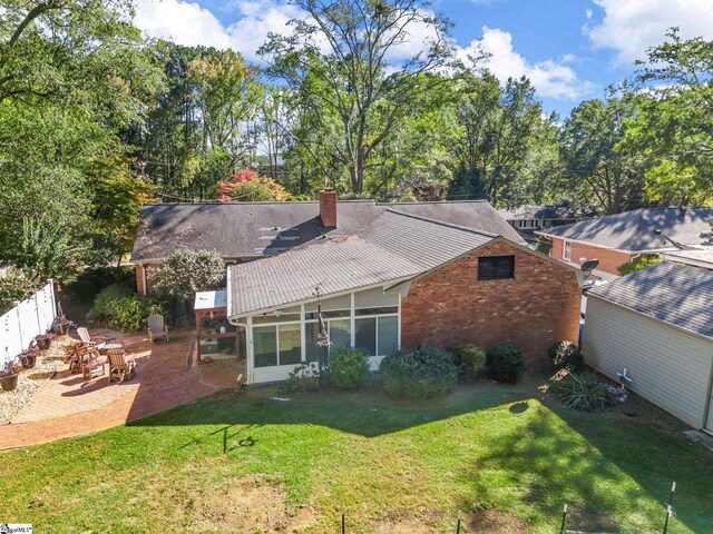 248 Greengate Ln, Spartanburg, SC 29307 - back of property featuring a lawn, brick siding, a chimney, and a patio area