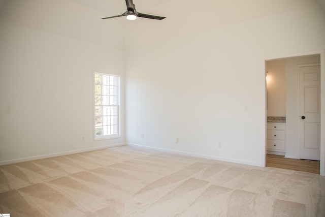 unfurnished room featuring ceiling fan and light colored carpet