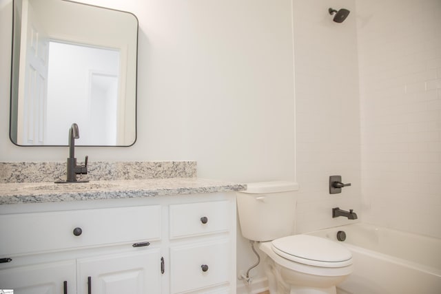 full bathroom with vanity, tiled shower / bath combo, and toilet