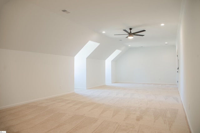 bonus room with ceiling fan, lofted ceiling, and light colored carpet