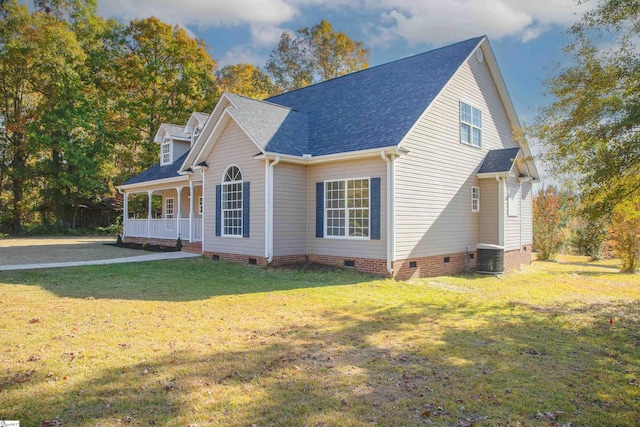 view of side of property featuring central AC, a yard, and covered porch