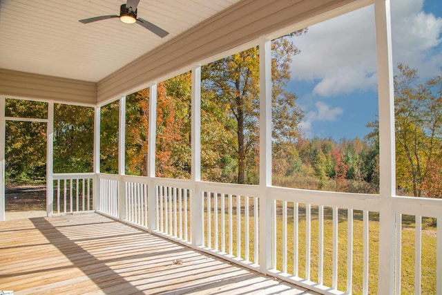 unfurnished sunroom featuring ceiling fan