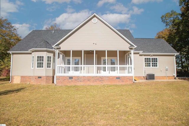 back of house featuring covered porch, central air condition unit, and a lawn