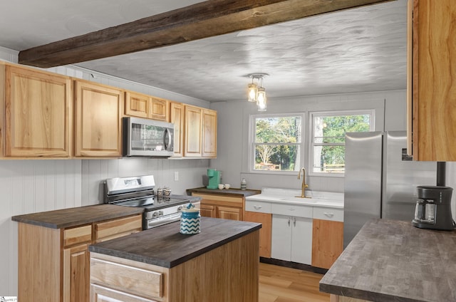 kitchen featuring stainless steel appliances, sink, beamed ceiling, light hardwood / wood-style floors, and decorative light fixtures