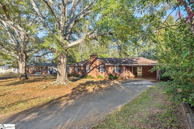 single story home featuring a carport