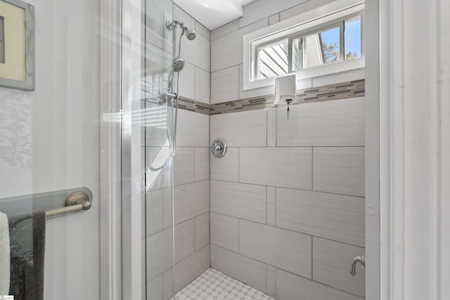 bathroom featuring a shower with door