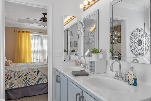 bathroom featuring vanity, ornamental molding, a textured ceiling, and ceiling fan