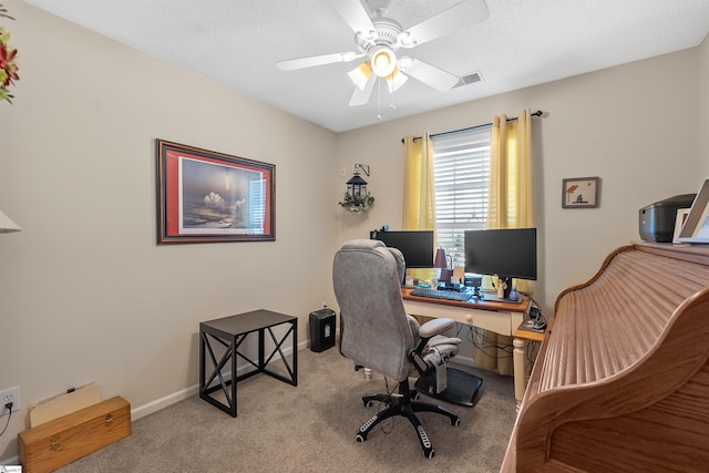 carpeted office with ceiling fan and a textured ceiling