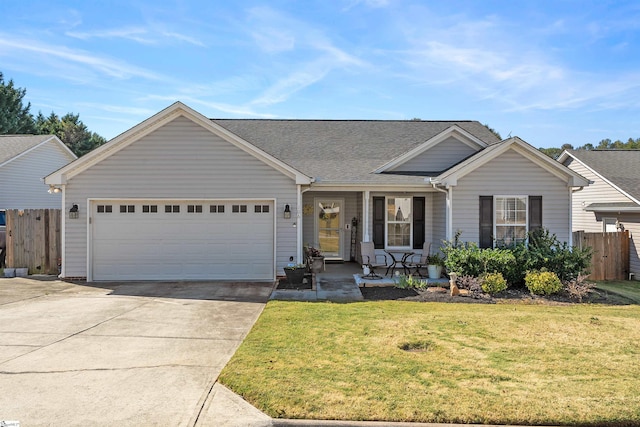 ranch-style house featuring a front yard and a garage