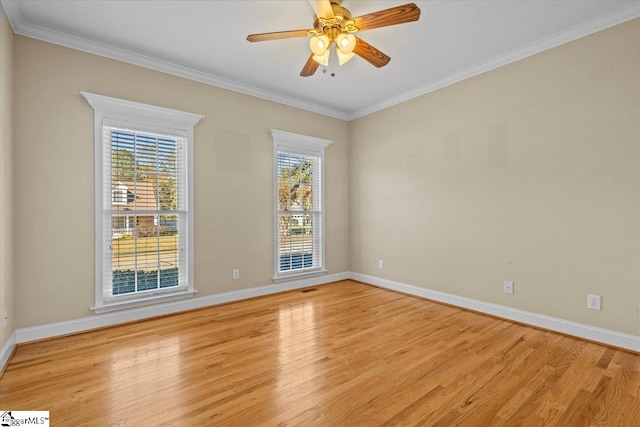 empty room featuring light hardwood / wood-style floors, crown molding, and plenty of natural light