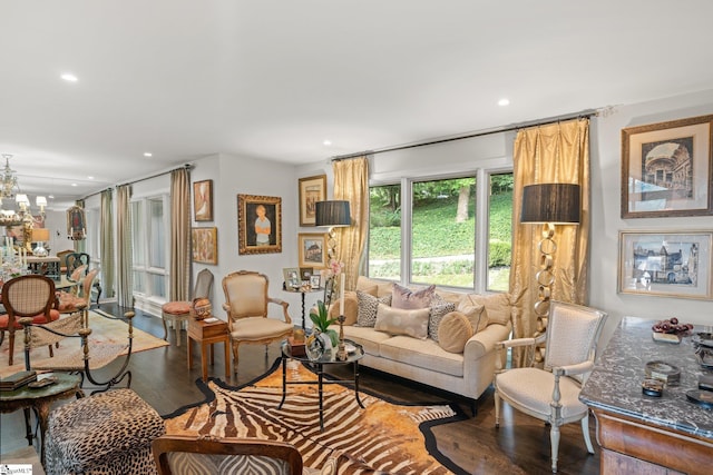 living room with an inviting chandelier and hardwood / wood-style flooring