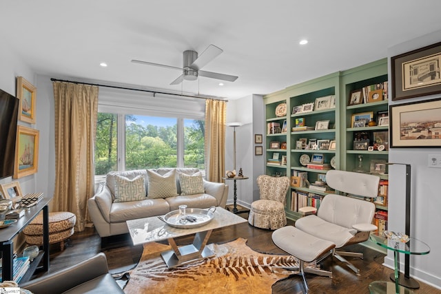 living room featuring dark wood-type flooring and ceiling fan