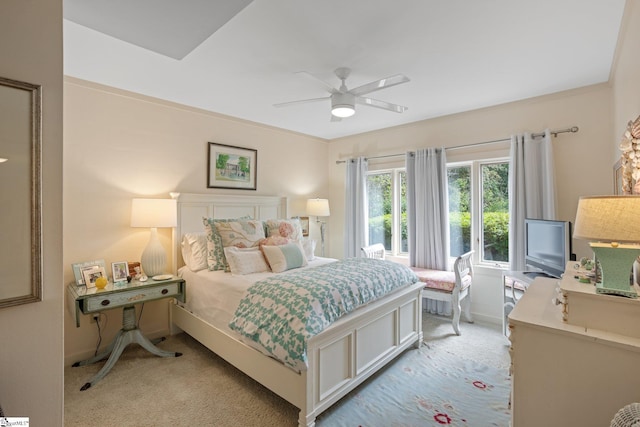 carpeted bedroom featuring ceiling fan and ornamental molding