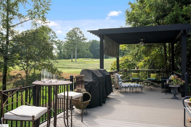 deck featuring area for grilling and ceiling fan