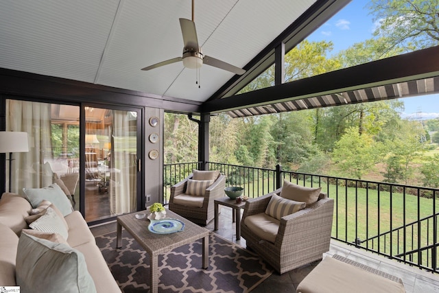 sunroom / solarium with a healthy amount of sunlight, ceiling fan, and vaulted ceiling