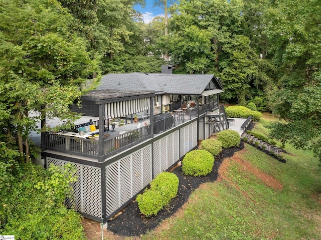 rear view of property with a wooden deck