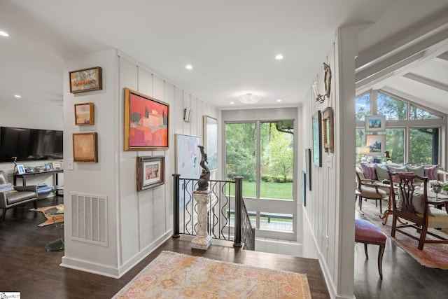 entryway featuring vaulted ceiling with beams and dark wood-type flooring