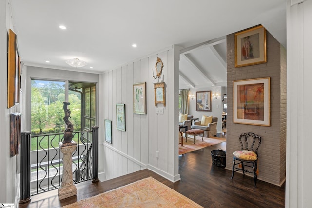 foyer featuring dark wood-type flooring and lofted ceiling with beams